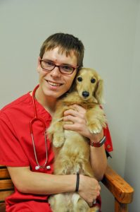 Team member Tanner Tilton with the office dog Gus